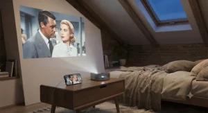 Wireless projector streaming a film via smartphone connection in a small loft conversion.