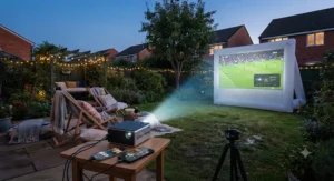 A rechargeable battery-powered pico projector streaming a match or film from an iPhone and Android smartphone onto a portable garden cinema screen outdoors.