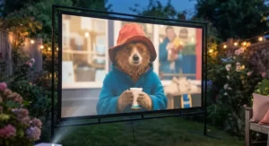 Close-up of a high-quality garden cinema projector screen displaying a crisp movie night film outdoors.