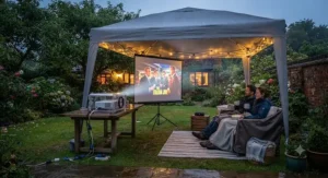 An outdoor cinema projector setup sheltered under a garden gazebo for unpredictable British weather